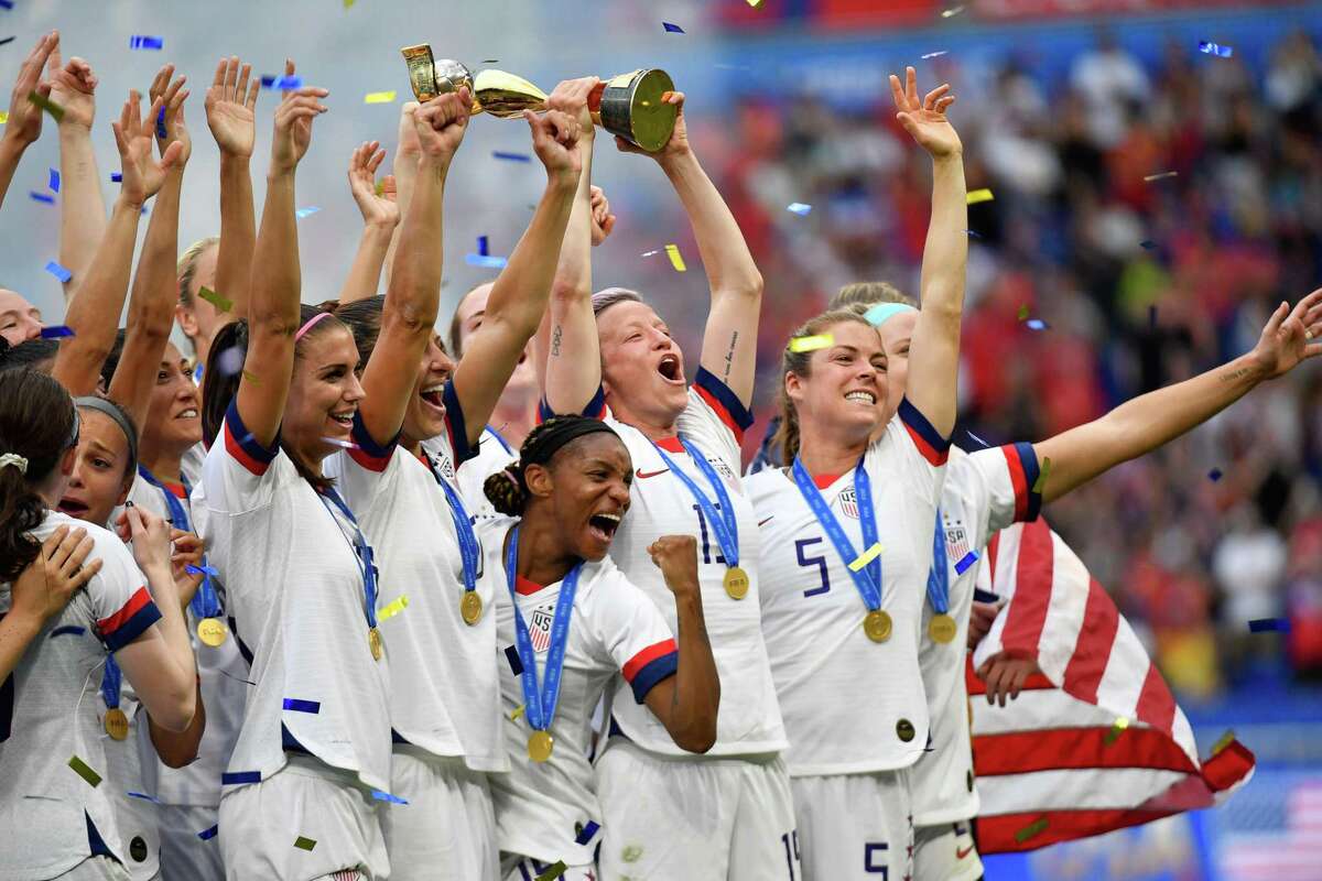 USA's players including forward Megan Rapinoe (C) celebrate with the trophy after the France 2019 Womens World Cup football final match between USA and the Netherlands, on July 7, 2019, at the Lyon Stadium in Lyon, central-eastern France.