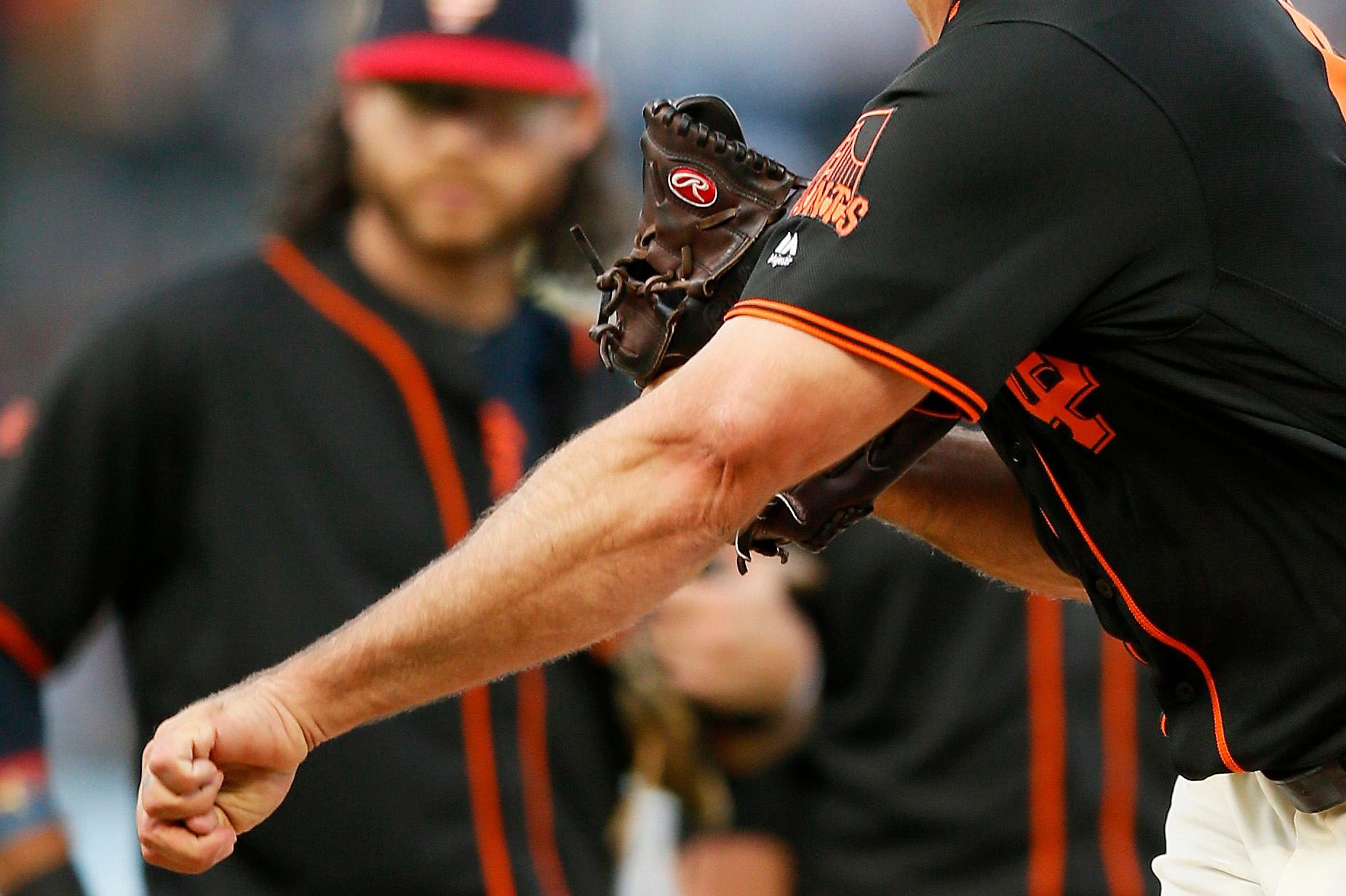 Giants announcer Mike Krukow leans on his service dog, Patriot, for support