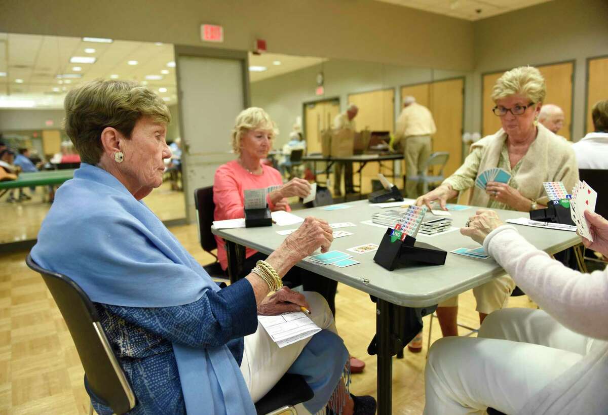 Greenwich's Karen Fox, left, Rye Brook, N.Y.'s Cynthia Bompey, center, and Riverside's Betsy Grant compete in the Fairfield County Duplicate Bridge match at the YWCA in Greenwich, Conn. Monday, July 1, 2019. The group meets every Monday for an official match franchised by American Contract Bridge League. Master points awarded throughout the season at players participating in 15 or more games are eligible for YWCA “Player of the Year” awards. The games are open to both members and non-members. In addition, on Fridays there are supervised bridge games in which interesting hands are chosen for a chalkboard explanation and discussion.