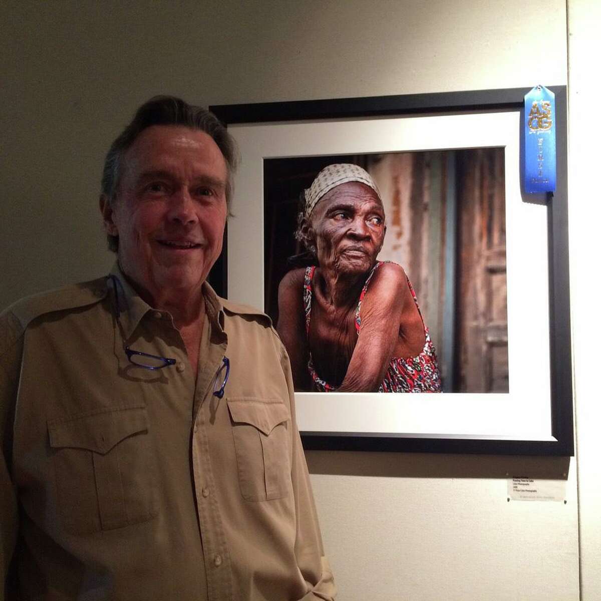 Gregory Presley with his photograph, “Passing Time in Cuba,” which took first place for color photography