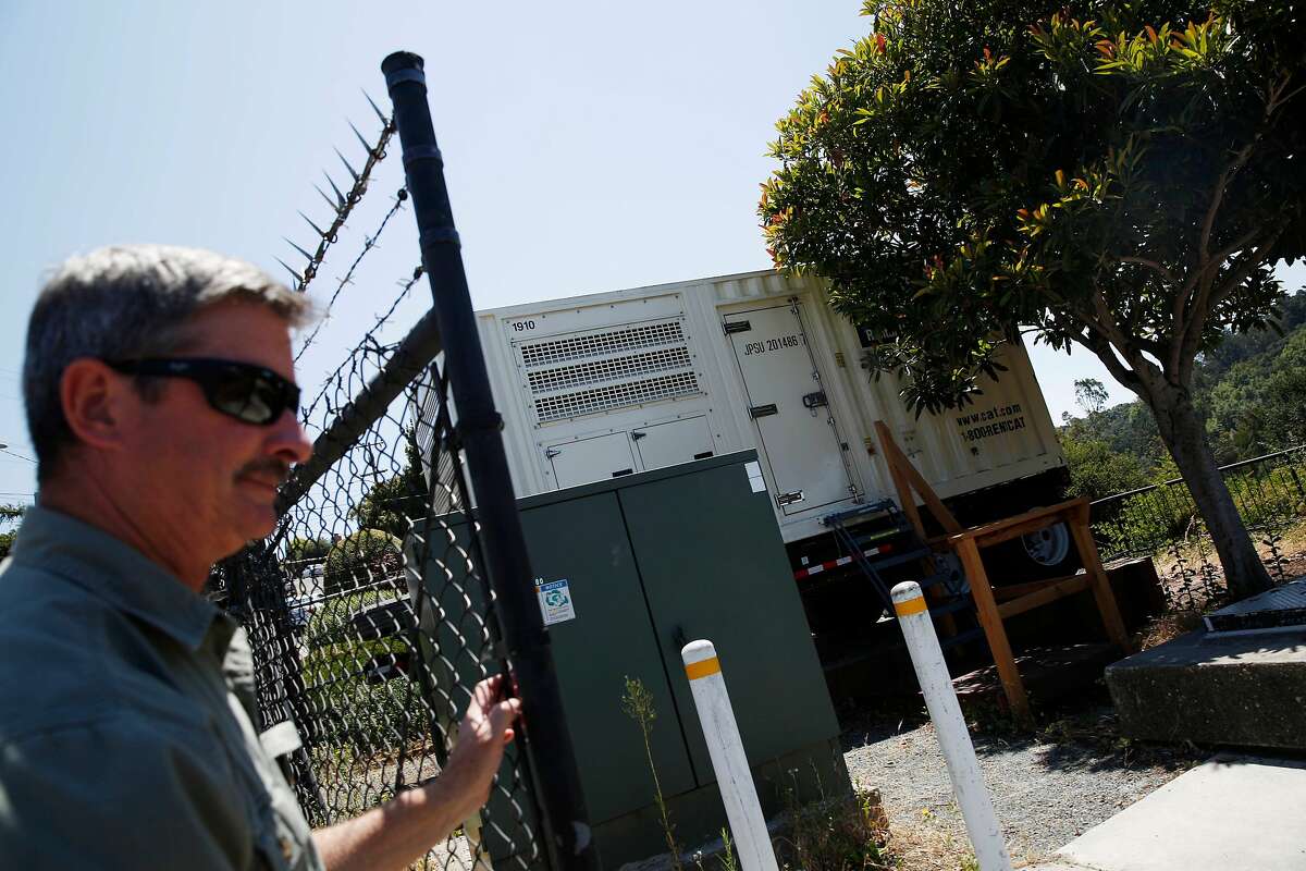 David Cherniss (l to r), East Bay Municipal Utility District mechanical supervisor opens a gate next to a portable generator at the Fontaine Pumping Plant on Friday, July 5, 2019 in Oakland, Calif.