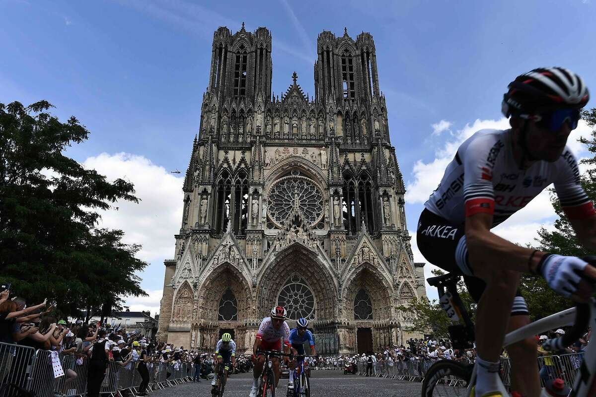 The pack rides with the Cathedral of reims in background during the third stage of the 106th edition of the Tour de France cycling race between Binche and Epernay, in Reims, on July 8, 2019. (Photo by JEFF PACHOUD / AFP)JEFF PACHOUD/AFP/Getty Images