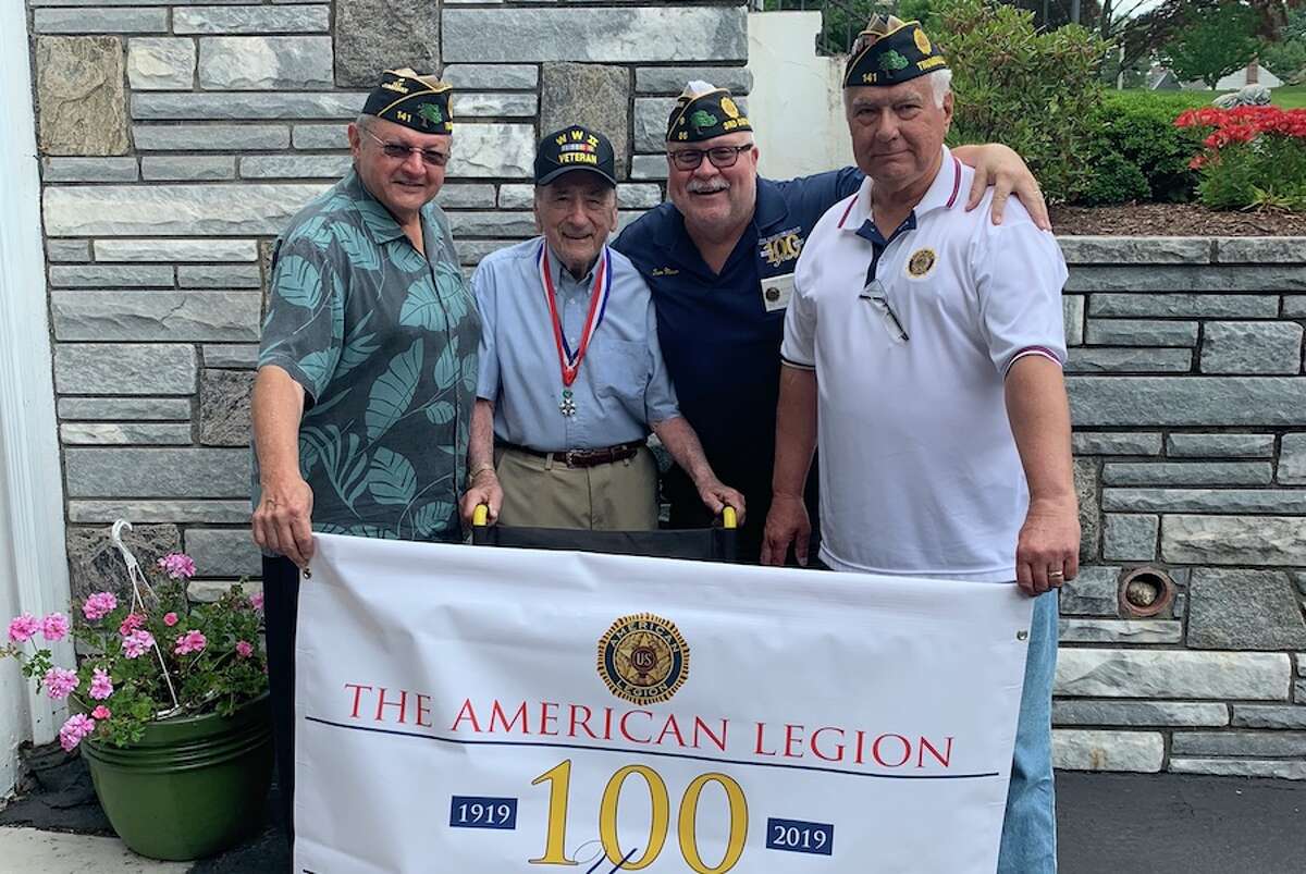 At the presentation of a wheelchair are, from left, Joe Montanaro (Senior VicecCommander of Post 141), Anthony Salce (World War II veteran and Post 141 member), Tom Moore (Adjutant of Post 86), and Ernie Foito (Commander of Post 141).