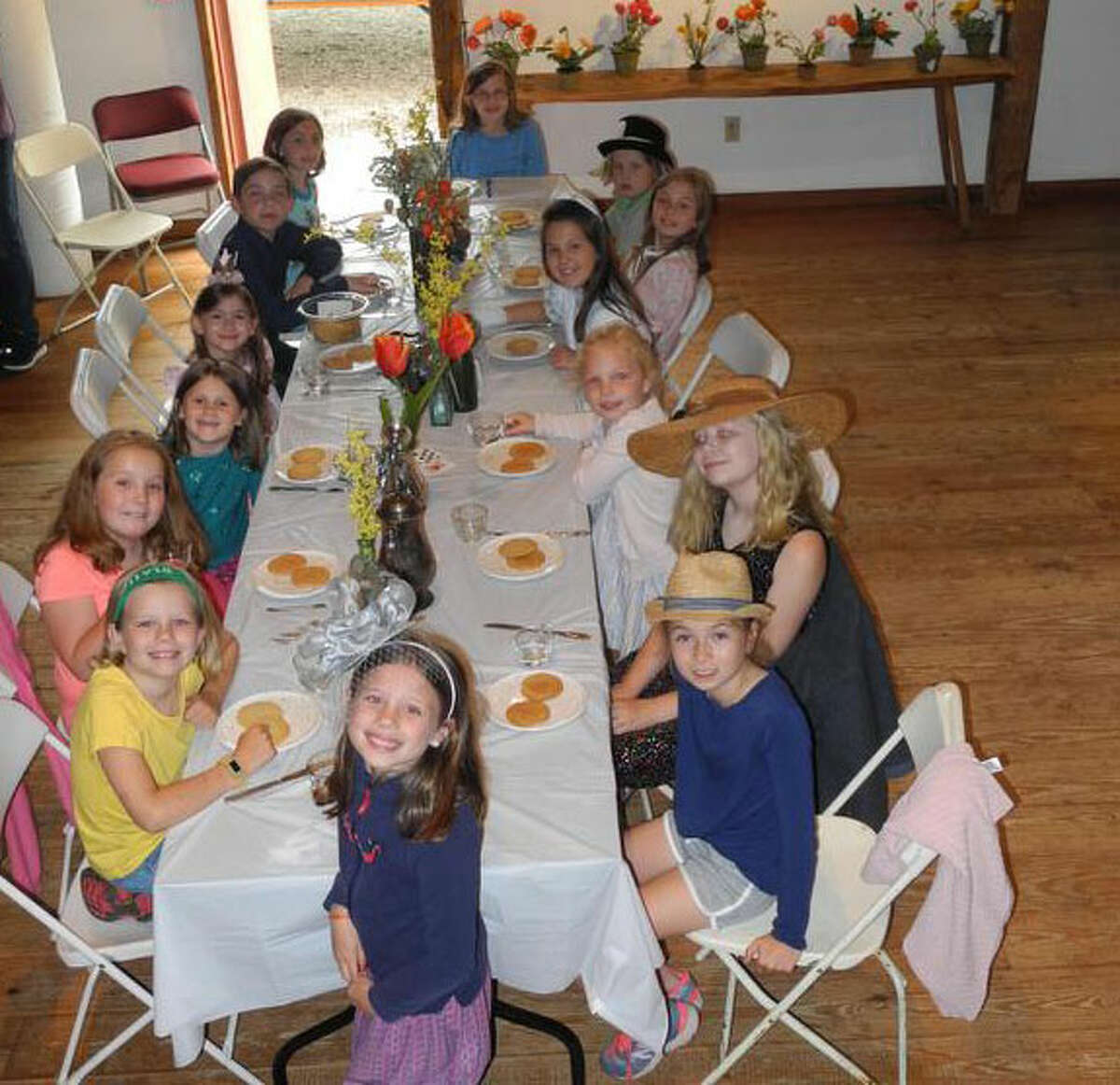 Fourteen boys and girls celebrated the end of the school year with a Mad Hatter’s tea party at the Wilton Historical Society on June 13. — Contributed photo