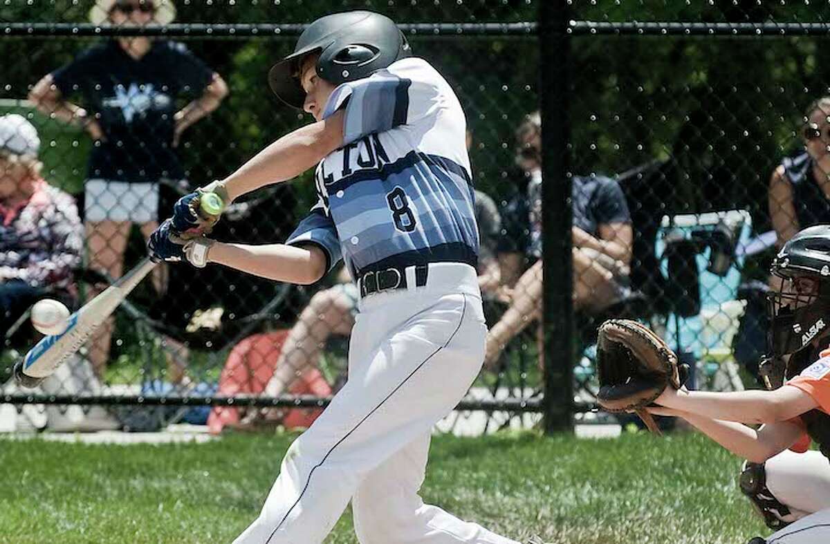 Tanner Schmauch connects with a pitch during Wilton's district tourney opener against Ridgefield. — Scott Mullin photo