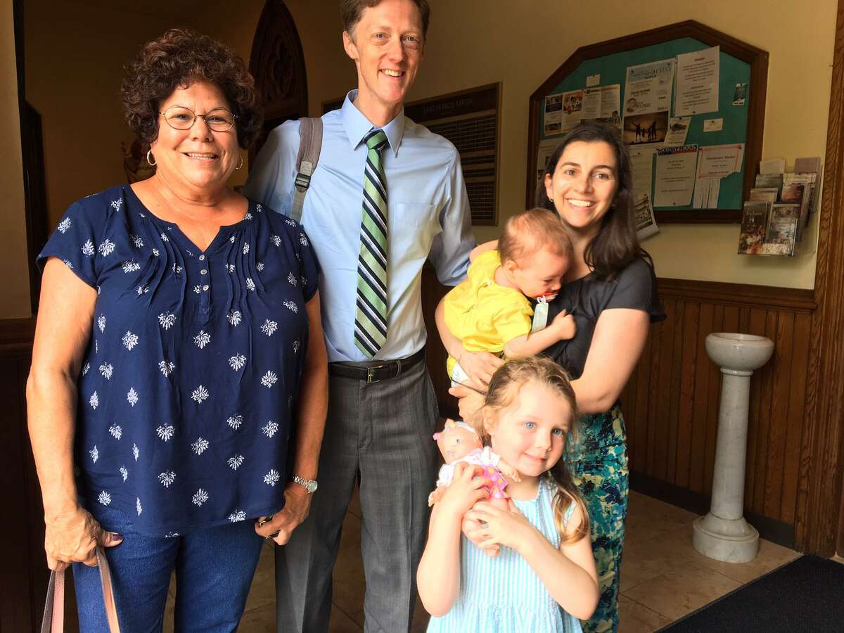 Cindy Culvert , left, with mayoral contender Justin Elicker, Natalie Elicker holding April Elicker, behind Molly Elicker at St. Francis Church.