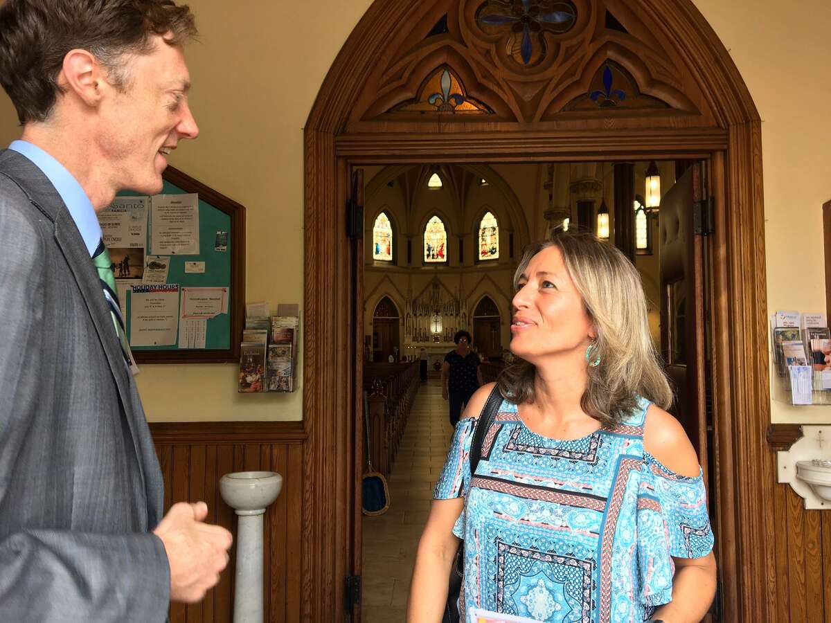 Gloria Vega, right, talks with mayoral contender Justin Elicker at St, Francis Church.