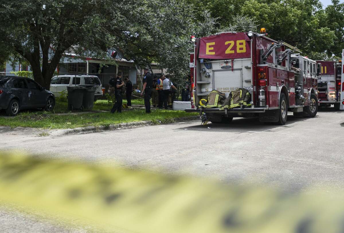 People morn after a fire killed a 19-year-old male in a house around the 1400 block of Bolivar Street in Beaumont on Monday. Photo taken on Monday, 07/08/19. Ryan Welch/The Enterprise