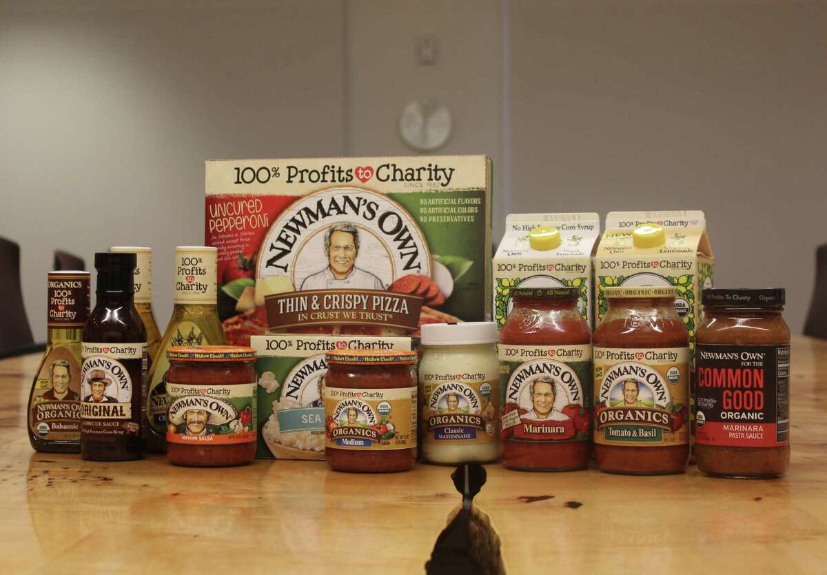 Newman's Own products wil soonl feature a bolder "100 percent profits to charity" label, replacing the previous "all profits to charity" located in smaller lettering under the company's name. Products with the new packaging are pictured Nov. 15, 2016 at Newman's Own's Westport, Conn. headquarters.