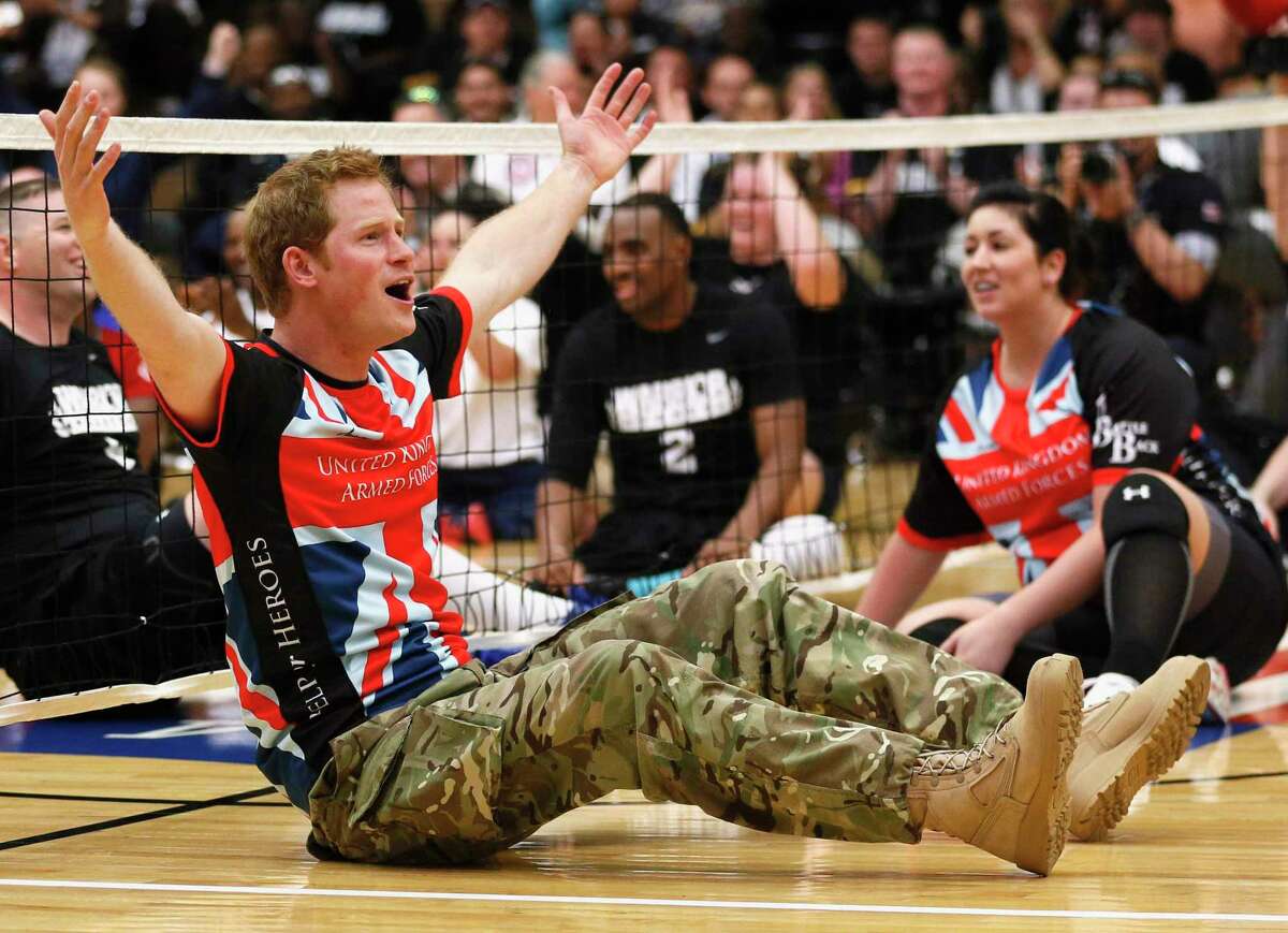 Britain's Prince Harry reacts while playing sitting volleyball with members of the British Warrior Games team in a gymnasium before the opening of the Warrior Games at the U.S. Olympic Training Center in Colorado Springs, Colorado in May 2013. The Warrior Games, organized by the U.S. Department of Defense, is a Paralympic-style competition featuring injured servicemen and women from six nations.