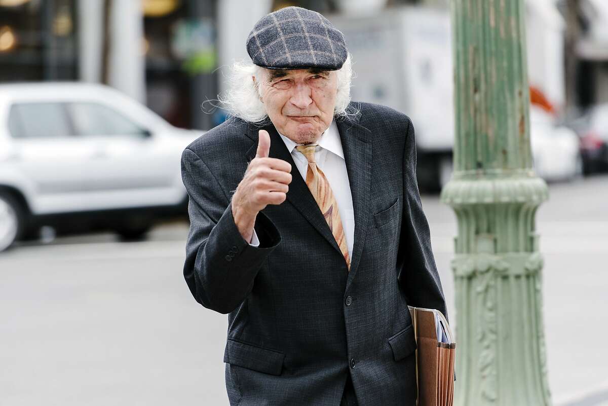 Defense attorney Tony Serra gives a thumbs-up as he walks towards the Alameda County Superior Court in Oakland, Calif., on July 9th, 2019, as his client, Derick Almena, is scheduled to take the stand for a second day.