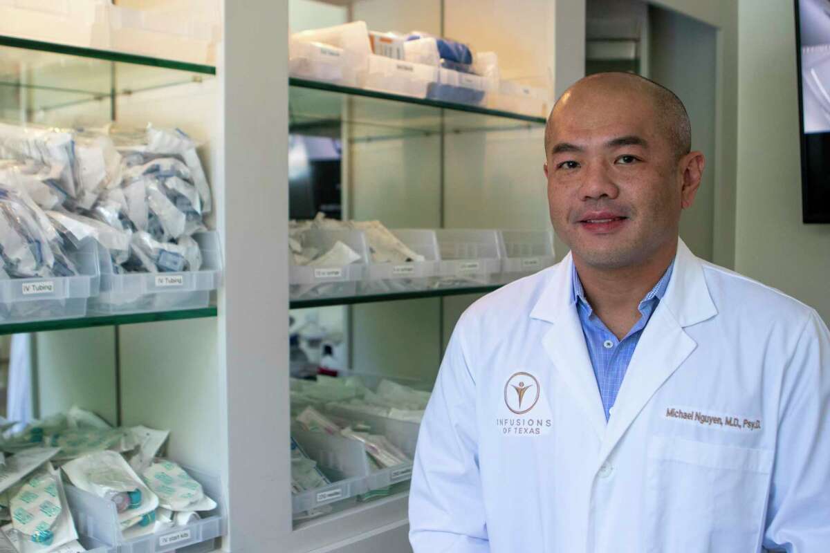 Medical director Dr. Michael Nguyen poses next to medical supplies Tuesday, July 9, 2019 at Infusions of Texas in The Woodlands.