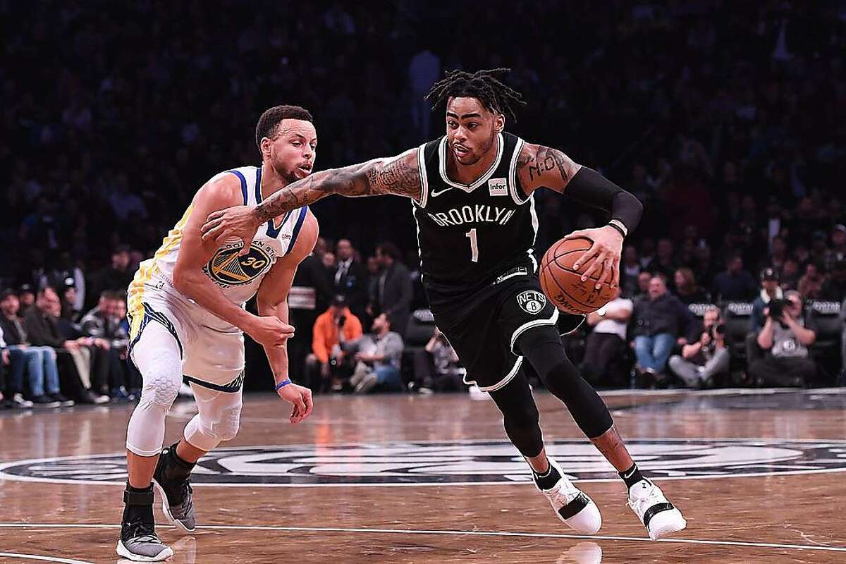 NEW YORK, NY - OCTOBER 28: D'Angelo Russell #1 of the Brooklyn Nets drives to the basket against Stephen Curry #30 of the Golden State Warriors during the game at Barclays Center on October 28, 2018 in the Brooklyn borough of New York City. NOTE TO USER: