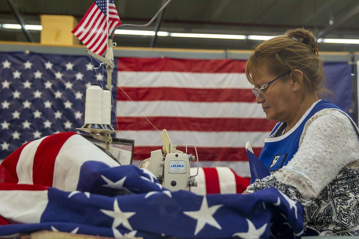 Ana Rosa Amador Hernandez works on stitching up an American flag at Goodwill South Florida in Miami, Florida, on Tuesday, July 2, 2019. (Charlie Ortega Guifarro/Miami Herald/TNS)