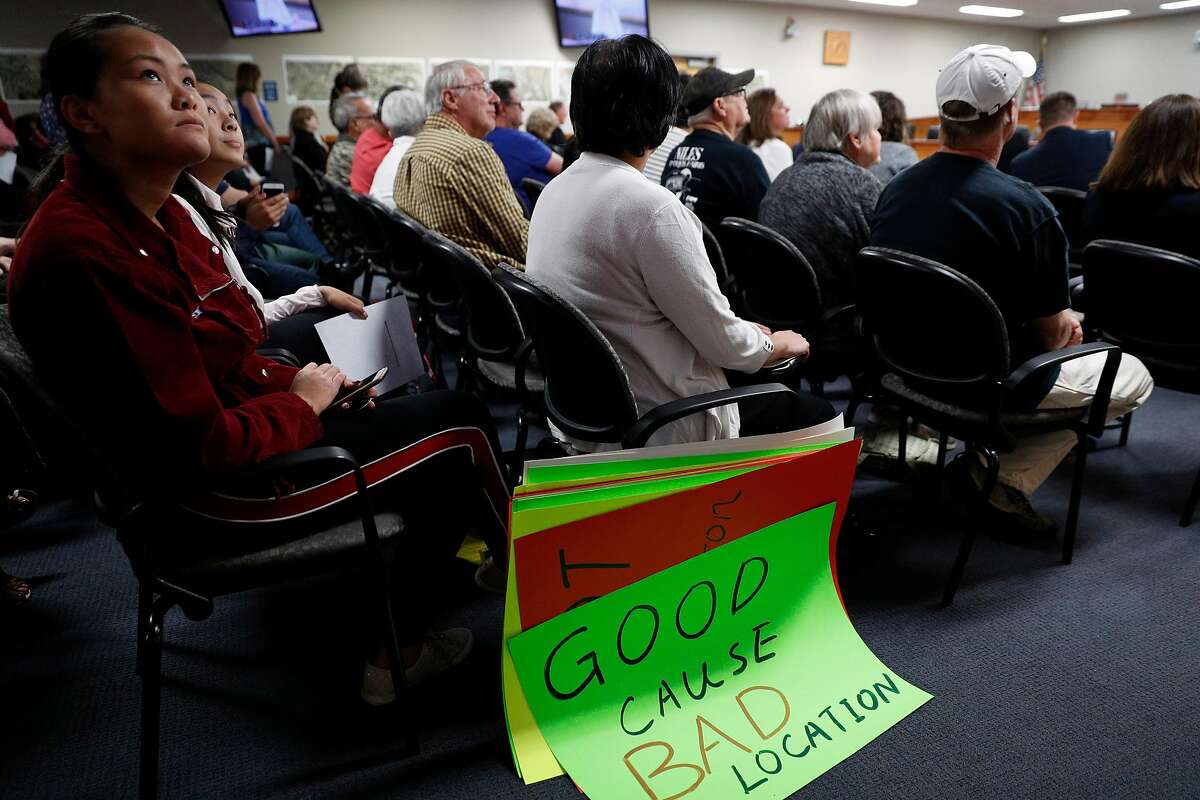 Caroline Xin listens to resident speakers during a meeting discussing possible locations for a homeless navigation center at City Council chambers in Fremont, Calif., on Tuesday, July 9, 2019. Fremont is considering locations to open a new navigation center in their city for the homeless. In September, the council will determine one specific location for the center-- which will house Fremont residents and other Alameda County residents. Residents agree that the city should do more to help the homeless, as long as its "not in their backyard."