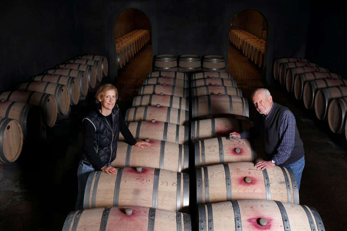 Philip Togni and his daughter Lisa stands among their family wine barrels, Tuesday March 11, 2014, at the Philip Togni Winery in St. Helena, Calif. After over 60 years of making wine Philip has settled atop Spring Mountain, outside St. Helena, where he still makes Cabernet very much in the style of the legendary 1969 Chappellet. He is believe to be one of the greatest American wines ever.