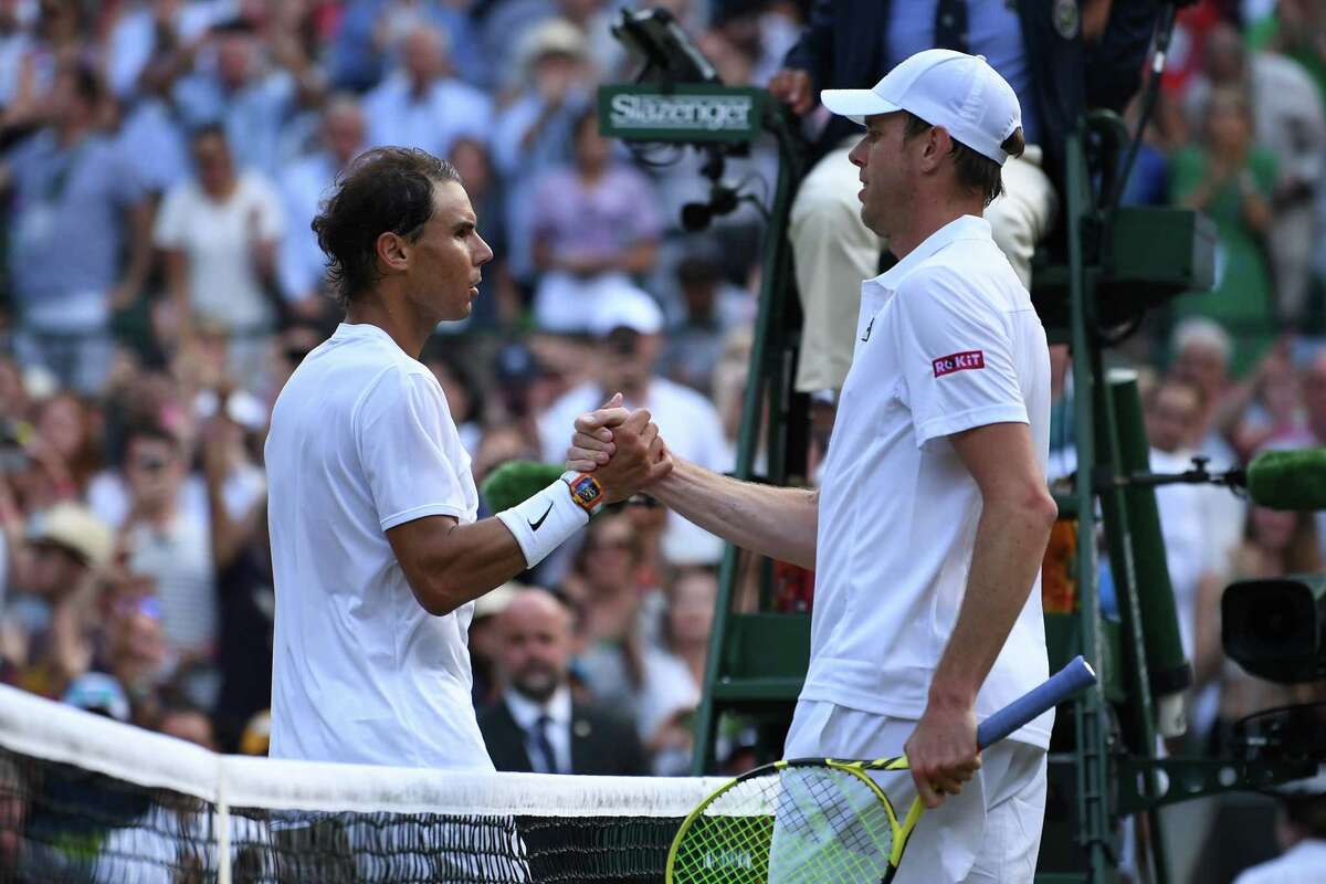 Spain's Rafael Nadal shakes hands with US player Sam Querrey during their men's singles quarter-final match on day nine of the 2019 Wimbledon Championships at The All England Lawn Tennis Club in Wimbledon, southwest London, on July 10, 2019. (Photo by Ben STANSALL / AFP) / RESTRICTED TO EDITORIAL USEBEN STANSALL/AFP/Getty Images