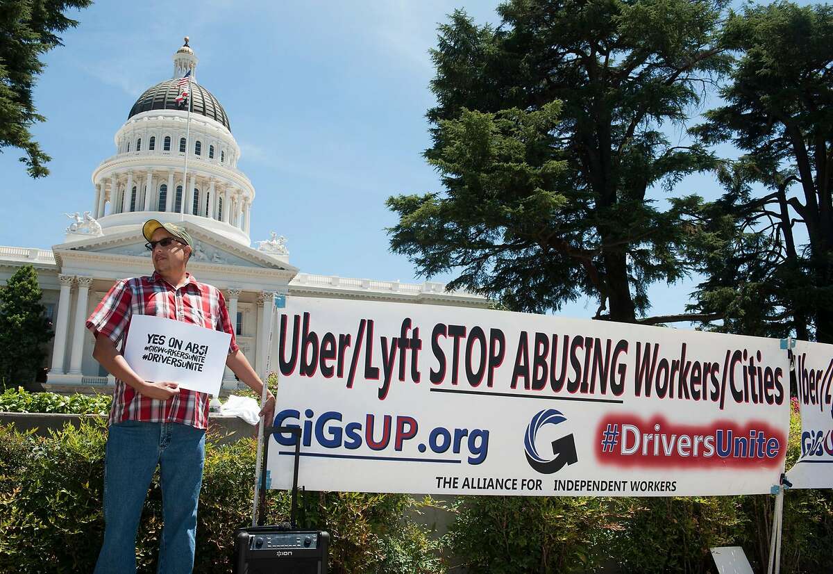 Carlos Pati�o of Sacramento has supplemented his income from his county government job by driving for Uber the last three years. He used to earn 80 percent of a ride and now it has dropped to 50 percent. He doesn't like this and is in favor of AB5. Drivers from Lyft and Uber rally against AB5, a bill that would turn drivers into employees on the west steps of the Capitol on Tuesday, July 9, 2019.