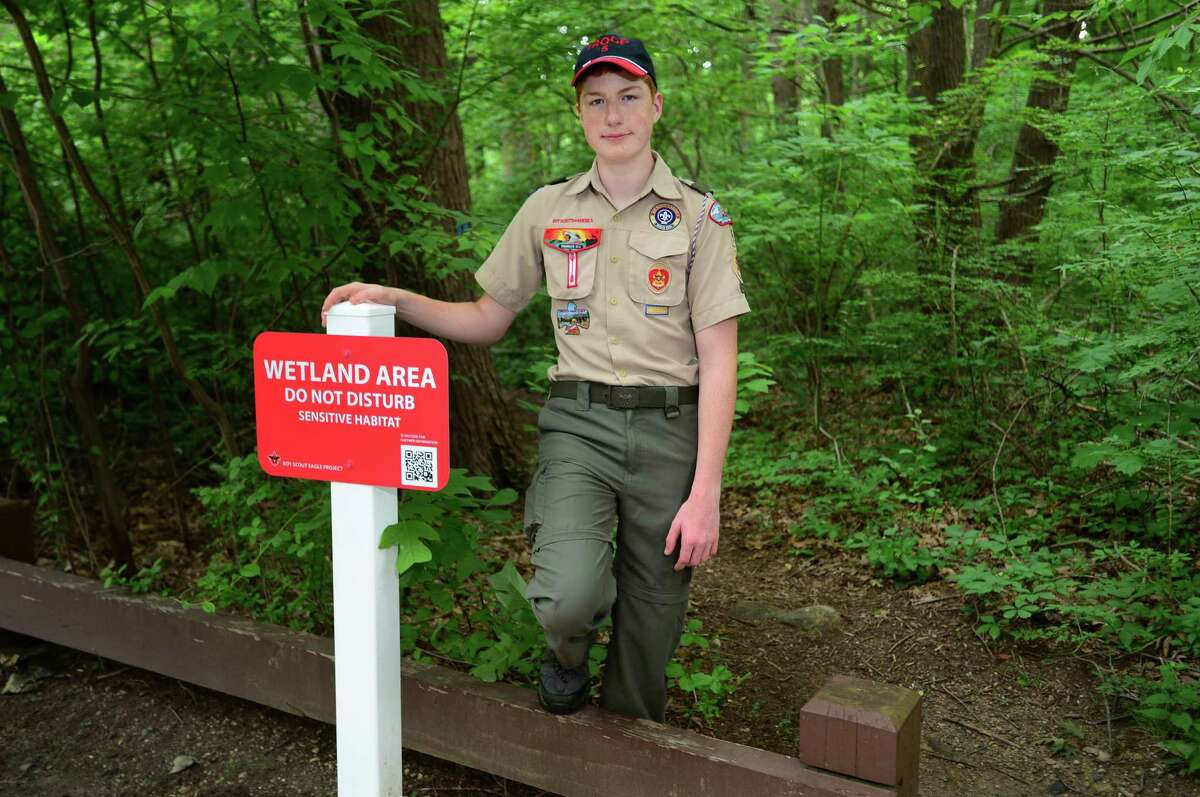 Life Scout Ryan Doyle with signs he had created for his Eagle Scout Project on Saturday, July 6, 2019, at Crabury Park in Norwalk. Doyle chose to protect the wetlands in Norwalk as his Eagle project. His project was to design and install signs in Cranbury Park that identify the wetland areas. He included a different QR code on each sign, so the park visitors can use their cell phones to scan the codes to get more information about wetland conservation.