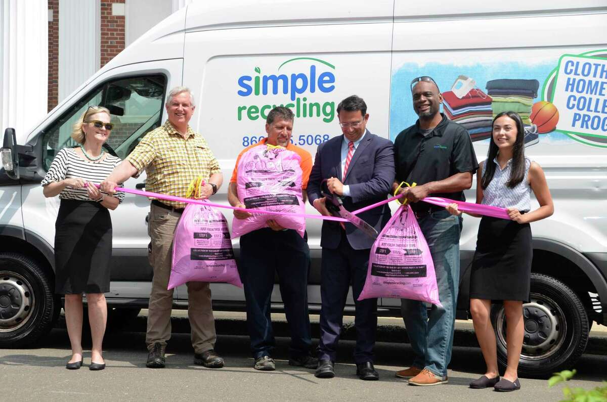 City and company officials gather July 10 in front of Milford City Hall to kick off a textile recycling program, which officially starts July 15, 2019. Pictured from left to right are Kristen Brown with WasteZero, Milford Open Space and Natural Resource Agent Steve Johnson, Milford Sanitation Foreman Bill Plantamura, Mayor Ben Blake, Sonny Wilkins with Simple Recycling, and Savannah Harik with WasteZero.