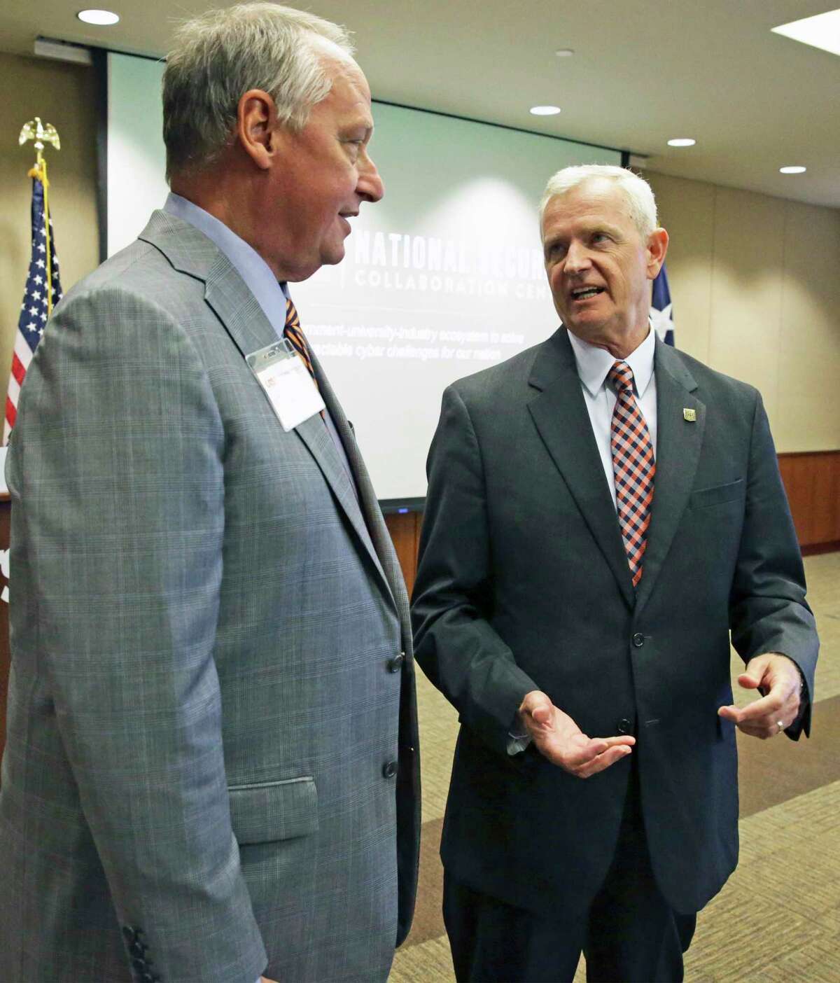 UTSA President Taylor Eighmy chats with his new hire Wednesday after the university announced Guy M. Walsh as its first executive director of its National Security Collaboration Center.