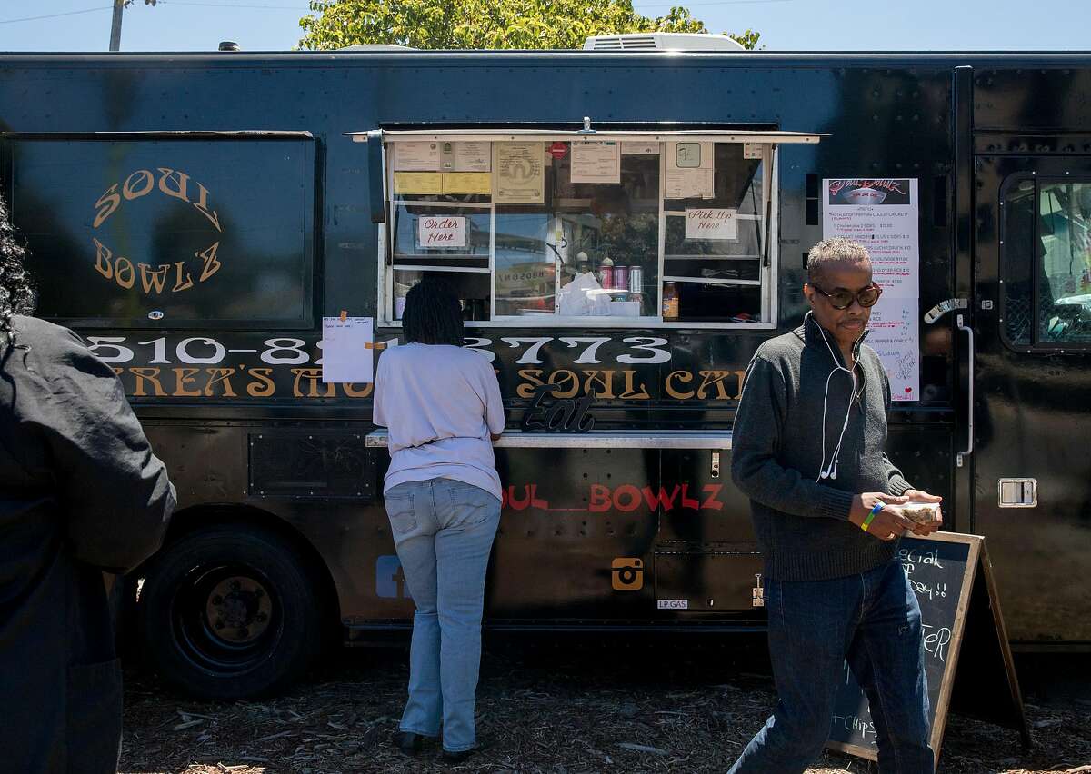 Customers order lunch from the Soul Bowl'z food truck at the Bayview Bistro food truck park in the Bayview district of San Francisco, Calif. Wednesday, July 10, 2019.