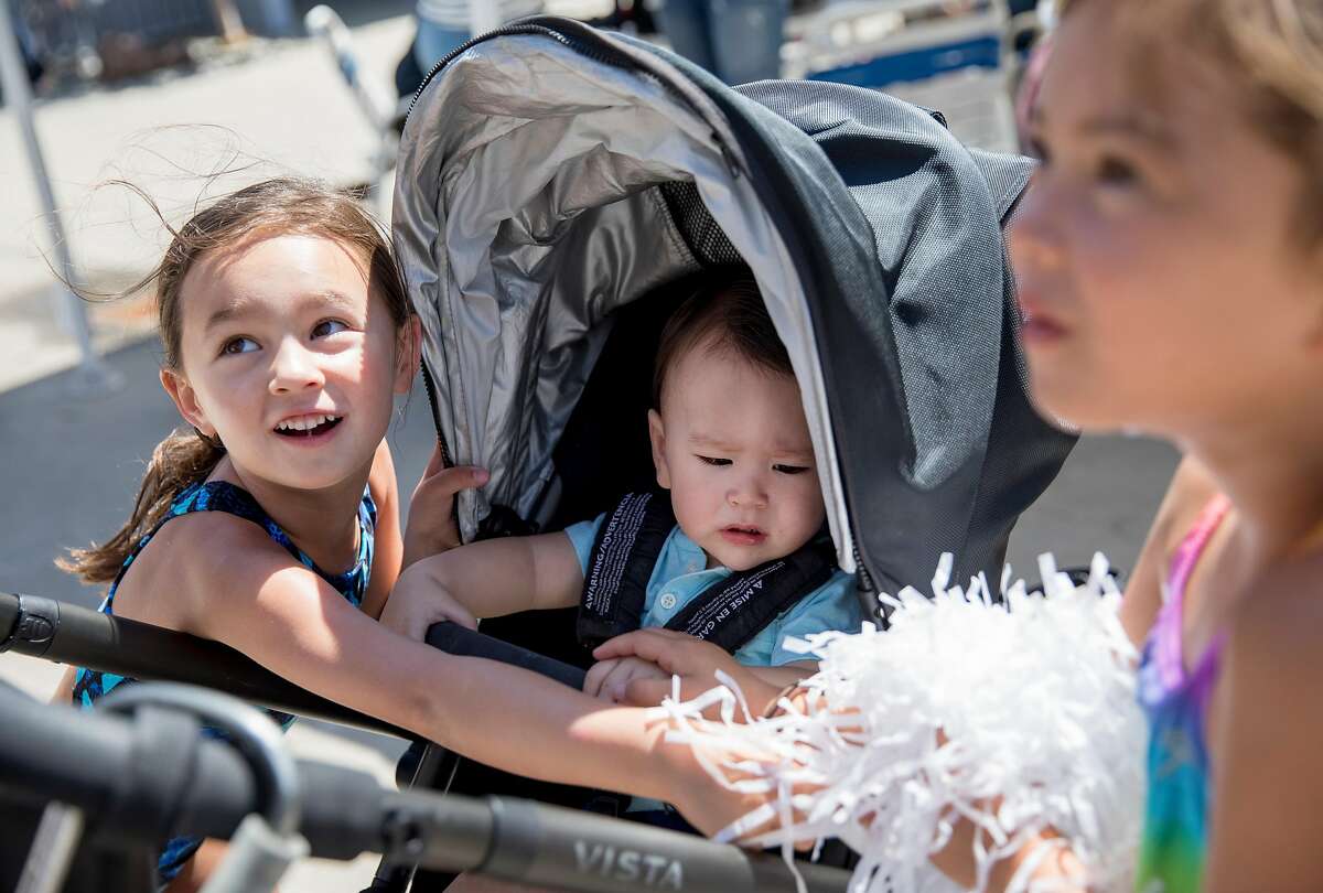 Campbell Lee, 5, (left) plays with her brother Colin, 10 months, and cousin Jane Peck, 7, before swimming at the Rancho San Miguel Swim Club in Walnut Creek, Calif. Tuesday, July 9, 2019.