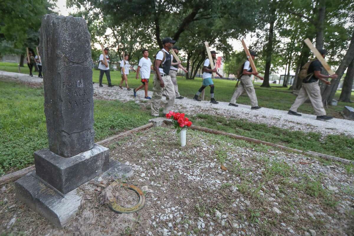 Performance artists depart the College Park Memorial Cemetery Tuesday, July 9, 2019, in Houston. Performance artist Jefferson Pinder and a group of about 12 other artists (half of whom are local; the others are from Chicago's Middle Passage Guerilla Theatre Company) rehearsed "Fire and Movement," a four-mile-long performance commissioned by DiverseWorks to recontextualize the history of the 1917 Camp Logan Uprising.