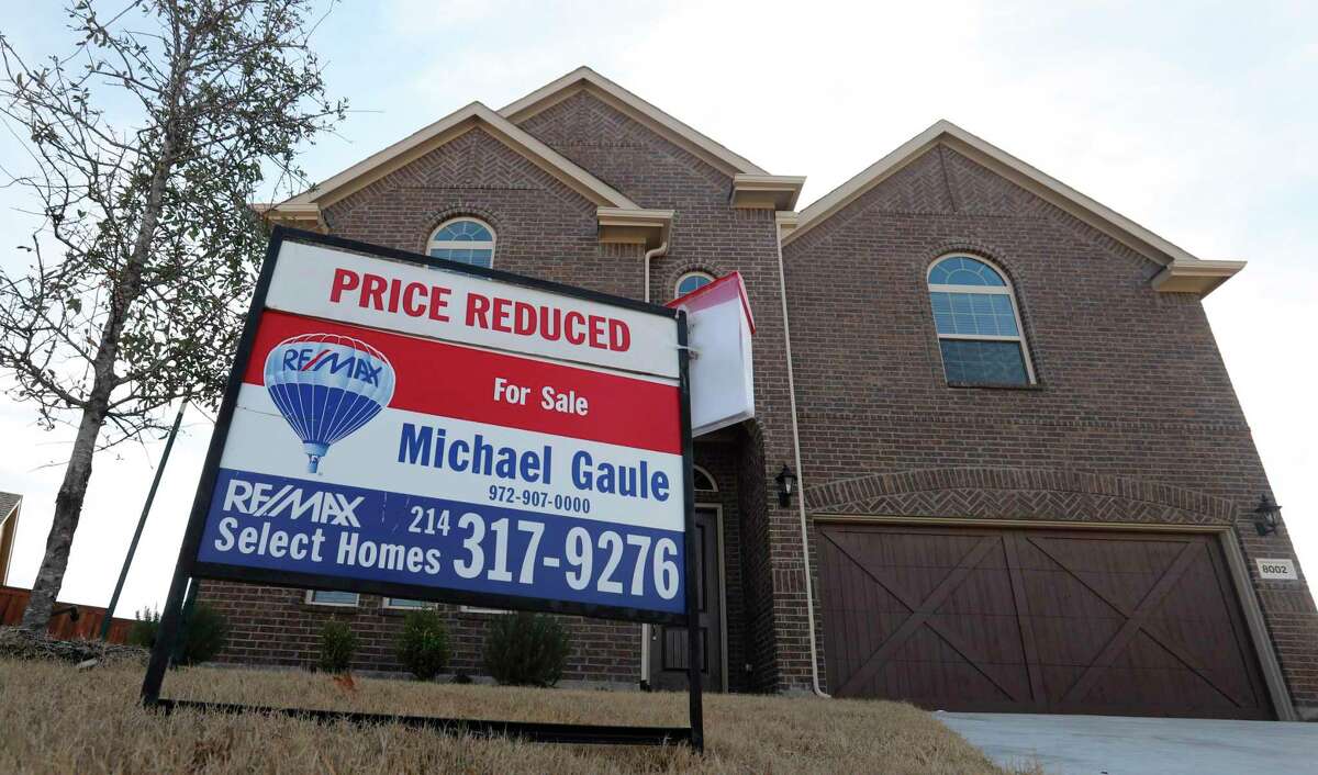 FILE - In this Wednesday, Feb. 20, 2019, photo a price reduced for sale sign sit in front of a home in north Dallas. On Thursday, May 30, Freddie Mac reports on this week’s average U.S. mortgage rates. (AP Photo/LM Otero, File)