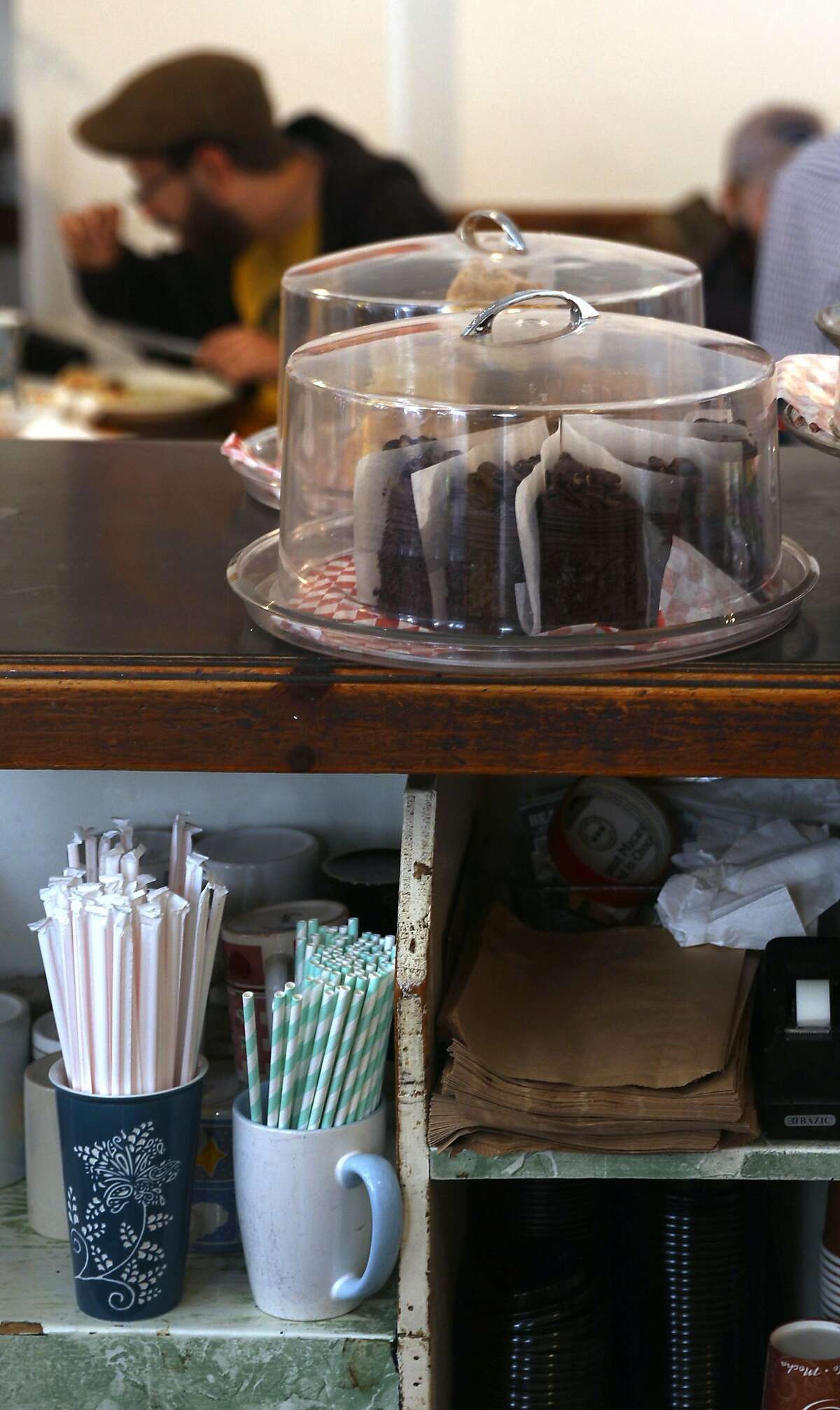 Cafe International has their paper and plastic straws seen stored behind the counter long on Tuesday, July 9, 2019, in San Francisco, Calif. The team from the San Francisco Dept. of the Environment go door to door to let restaurants know about the new law that started July 1, under which restaurants cannot automatically give out plastic utensils, napkins, condiment packages and other disposable items to diners, whether eat-in or take-in. They can give out the items upon request or can offer them in a self-serve area.