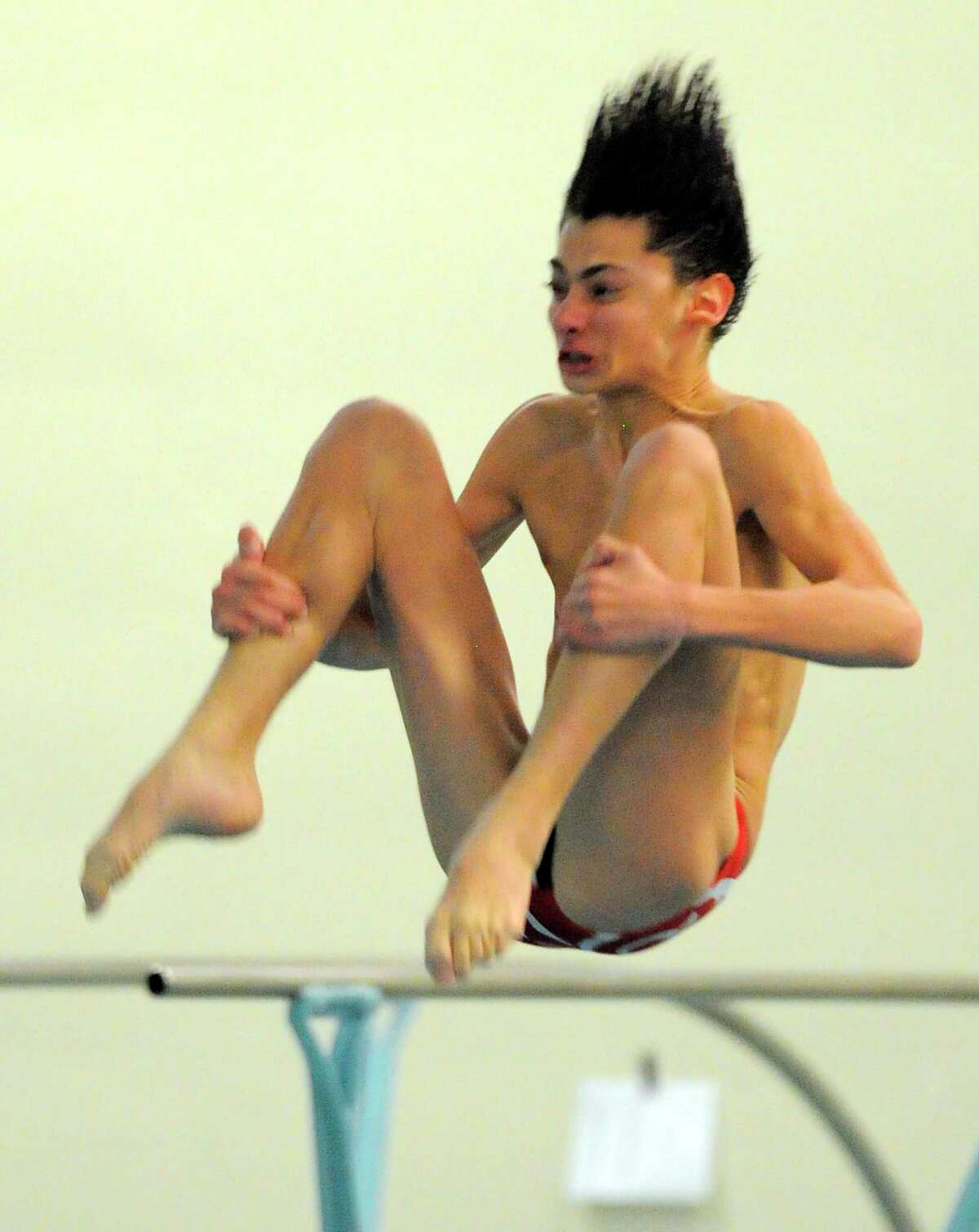 New Canaan Jackson Camporin competes in the FCIAC diving championships at the Westhill High School pool in Stamford.