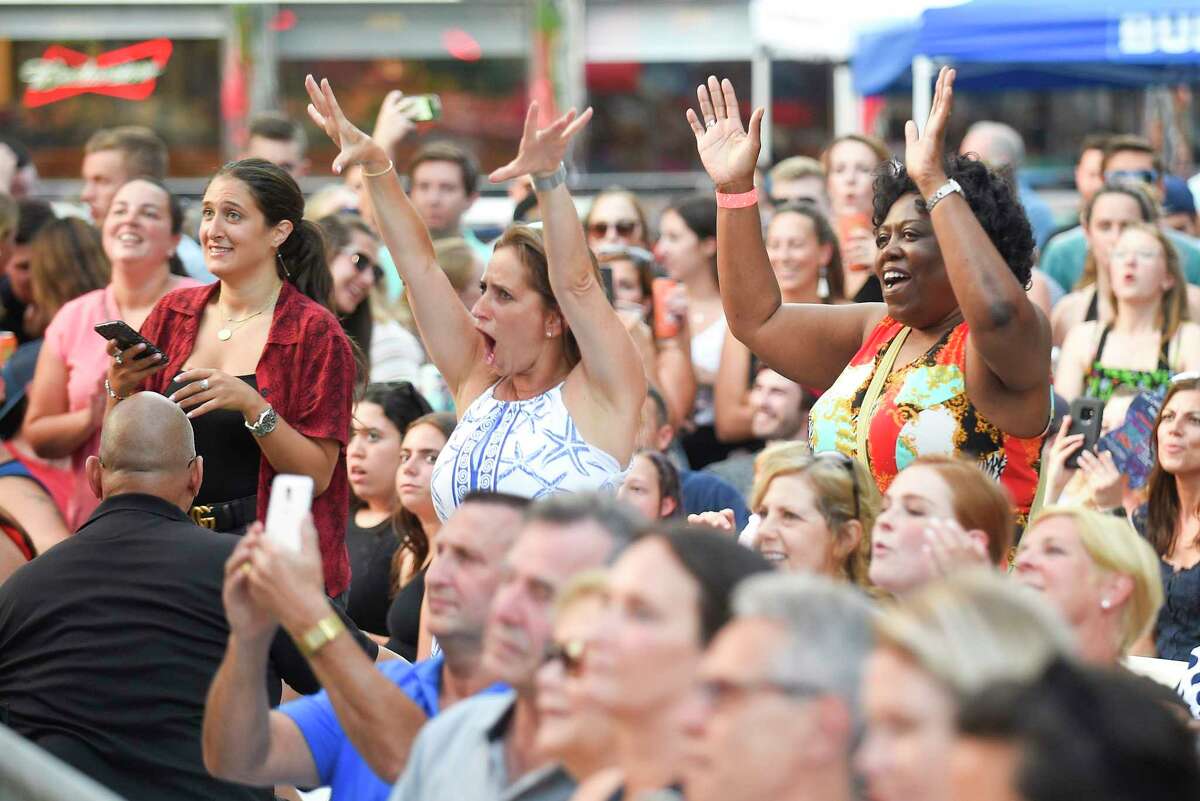 Concert fans dance to Andy Grammer's hit song "Don't Give Up On Me" as he performs at the Wednesday Nite Live in Stamford, Conn. on July 10, 2019. Hundreds of music fans packed into Stamford's Columbus Park to enjoy Grammer and the opening band Raquel and The Wildflowers, as they kicked off to the annual summer concert series.