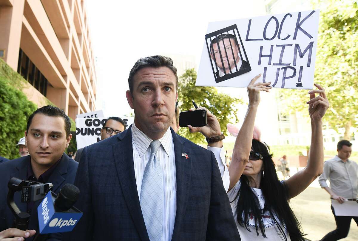 FILE - In this July 1, 2019, file photo, U.S. Rep. Duncan Hunter, R-Calif., center, leaves federal court after a hearing in San Diego. A judge is expected to rule on a bid by Hunter to move his trial on charges that he looted campaign funds for personal use and even to dismiss the charges outright. U.S. District Judge Thomas Whelan in San Diego decided a flurry of pretrial motions last week but deferred some decisions until Monday, July 8 to consider filings that arrived too late for him to read. (AP Photo/Denis Poroy, File)