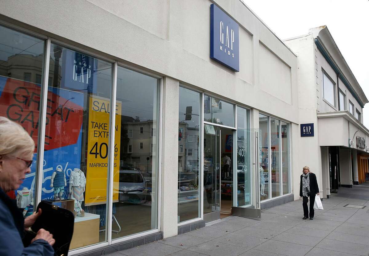 Pedestrians walk past the Gap Kids store in the Laurel Village shopping district in San Francisco, Calif. on Thursday, July 11, 2019, which may close by the end of the month. Several businesses along the strip on California Street have suddenly shut their doors for good.