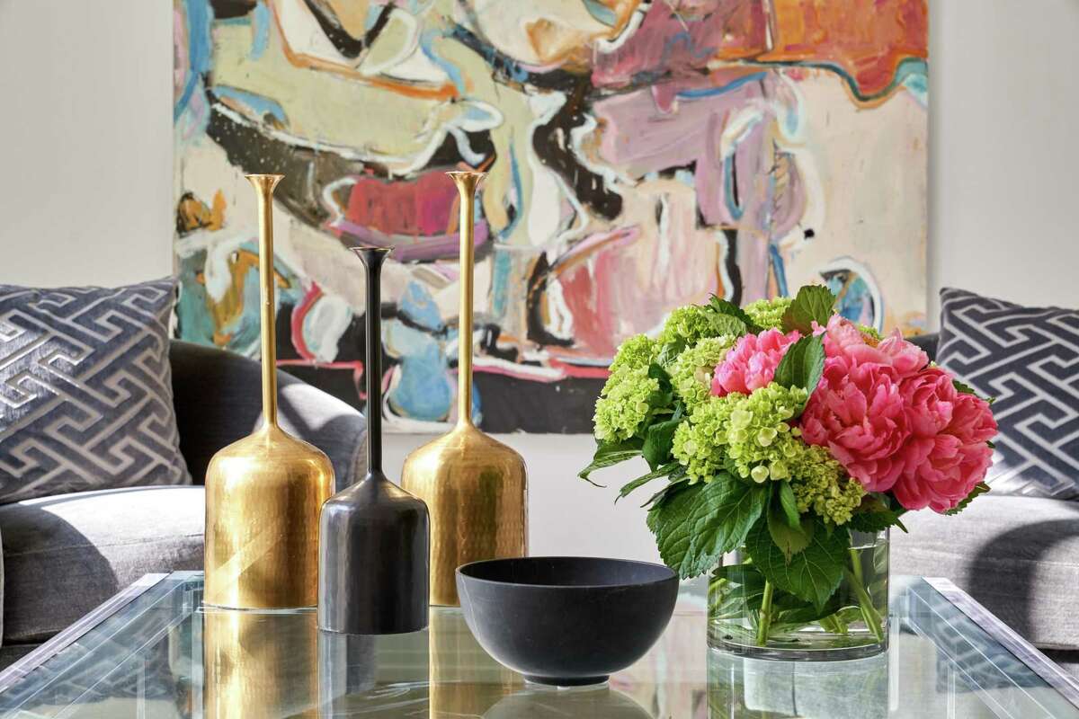 Though the furnishings are gray, art provides lots of color in the room.