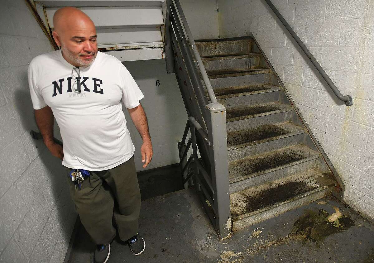 Charles F. Greene Homes residents' board Vice President Richard Pezzella gives a tour of the Building 5 stairwells that he says visitors use as bathrooms following a press conference at the low income housing complex in Bridgeport, Conn. on Thursday, July 11, 2019. The city is preparing an application to the federal government to have the troubled complex torn down.
