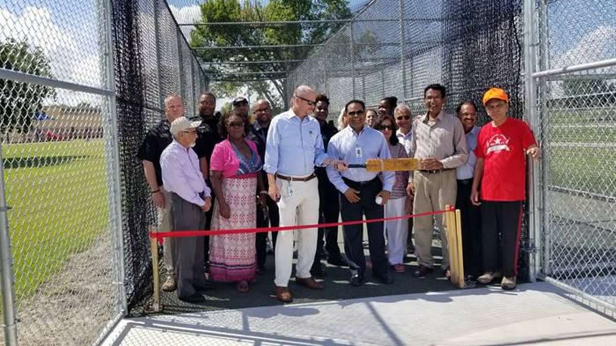 Fort Bend County Judge K.P. George and Precinct 4 Commissioner Ken DeMerchant, with community members, participate in the ribbon cutting ceremony for a new cricket field.