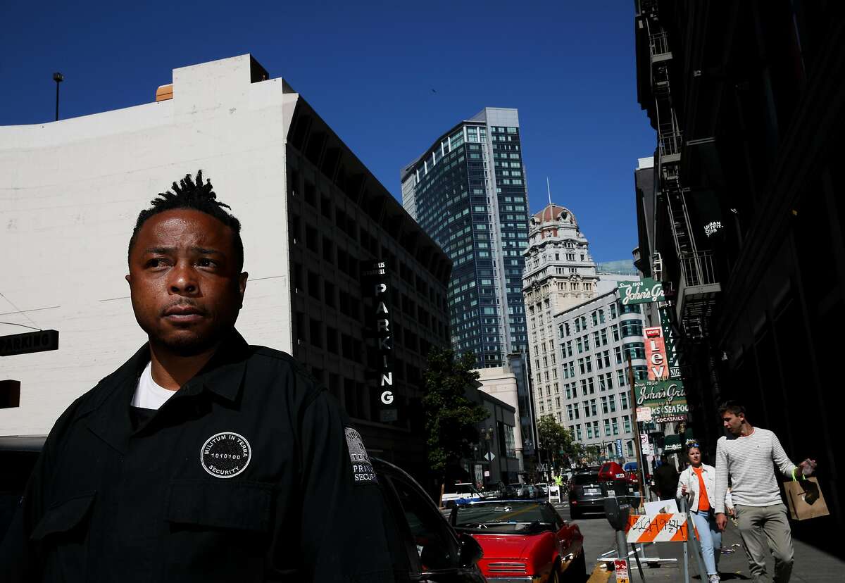 LaRance Braggs, 39, observes foot traffic outside Urban Outfitters, located at 80 Powell St., during his shift in San Francisco, Calif., on Sunday, June 30, 2019. A month ago Braggs, a Marine veteran, was homeless and living in his car on MLK Jr. Way in West Oakland. With help from Bay Area organization Swords to Plowshares, a program for military veterans, Braggs was recently hired as a supervisor for MINT Security, a private security service based in San Francisco. "Being a security guard is more than just trying to tell somebody what to do," Braggs said. "To me I feel like it�s providing a public service to people, you know, because it can really change somebody�s outlook on that day."