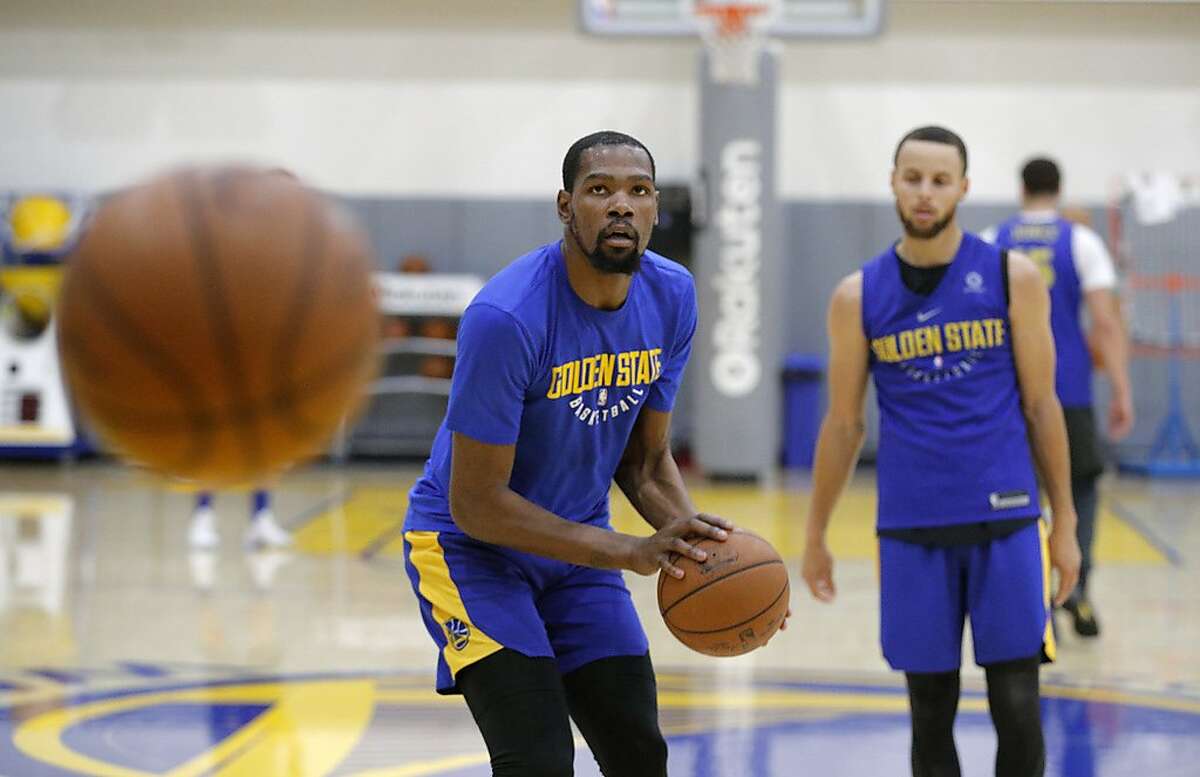 Warriors Kevin Durant, 35 and Warriors Stephen Curry, 30 run drills during a practice session at their facility in downtown in Oakland, Ca. on Fri. May 11, 2018.