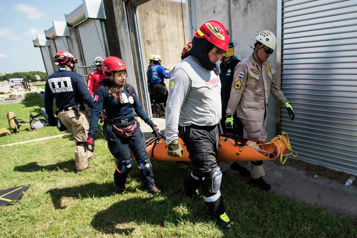 Emergency responders from Latin America carry a mannequin from a collapsed building as they work through rescue simulation while training at Disaster City on Wednesday, July 10, 2019, in College Station.