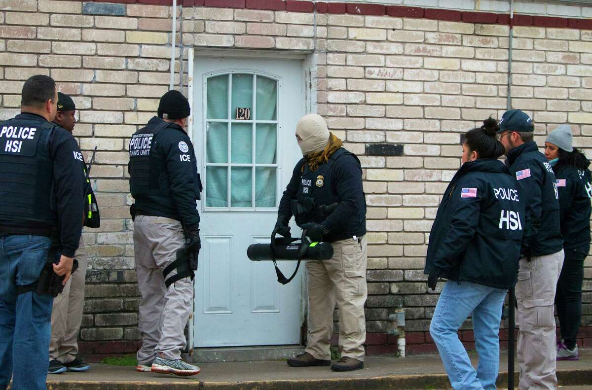 Police arrest suspects after raiding a business in southwest Houston in January 2014. Raids reportedly planned in Houston and other cities starting Sunday differ from previous enforcement efforts in scope and targets, focusing on recently-arrived immigrant families.