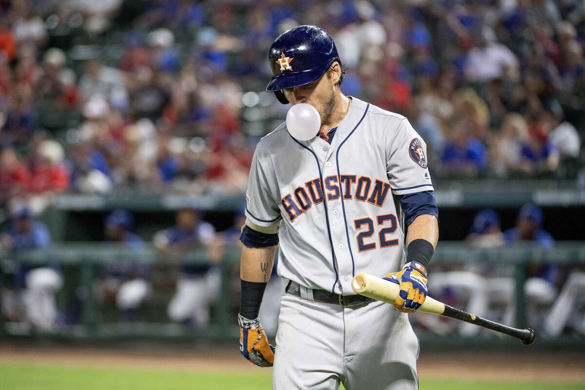 Houston Astros' Josh Reddick (22) blows a bubble after striking out against Texas Rangers relief pitcher Chris Martin during the ninth inning of a baseball game, Thursday, July 11, 2019, in Arlington, Texas. Texas won 5-0. (AP Photo/Jeffrey McWhorter)