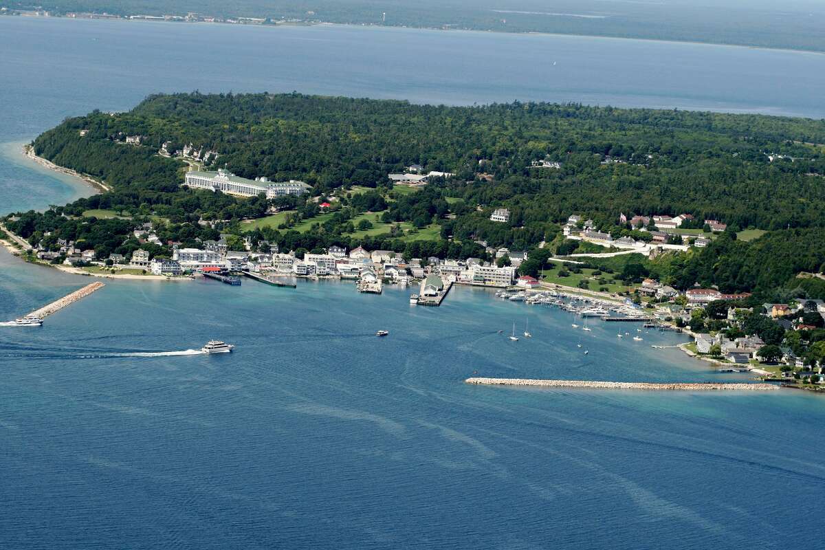 The Grand Hotel is easily visible in this aerial view of Mackinac Island and its main harbor.