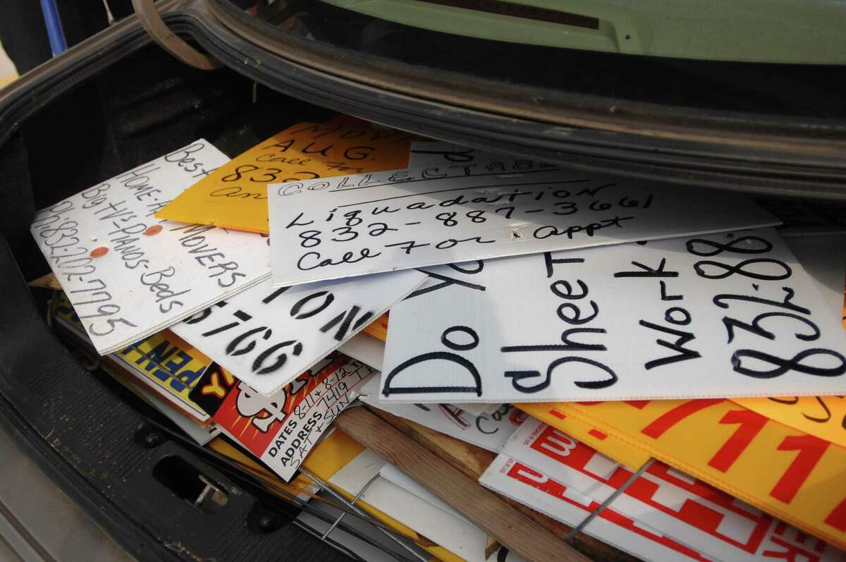 A trunk full of illegal bandit signs were collected along FM 1960 on 9/1/07. Photo by Thomas Nguyen/For the Chronicle.