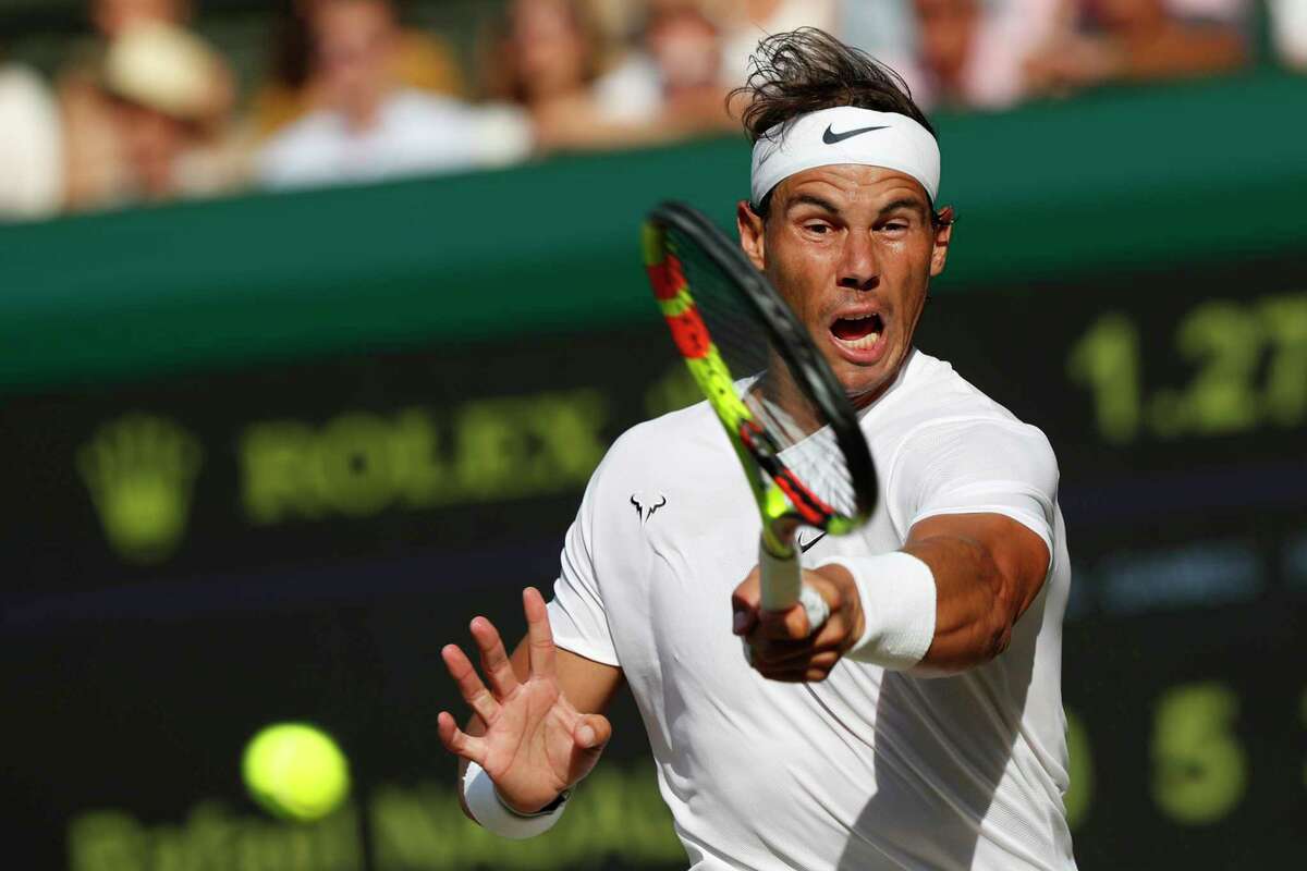 Spain's Rafael Nadal returns to Switzerland's Roger Federer in a Men's singles semifinal match on day eleven of the Wimbledon Tennis Championships in London, Friday, July 12, 2019. (Adrian Dennis/Pool Photo via AP)