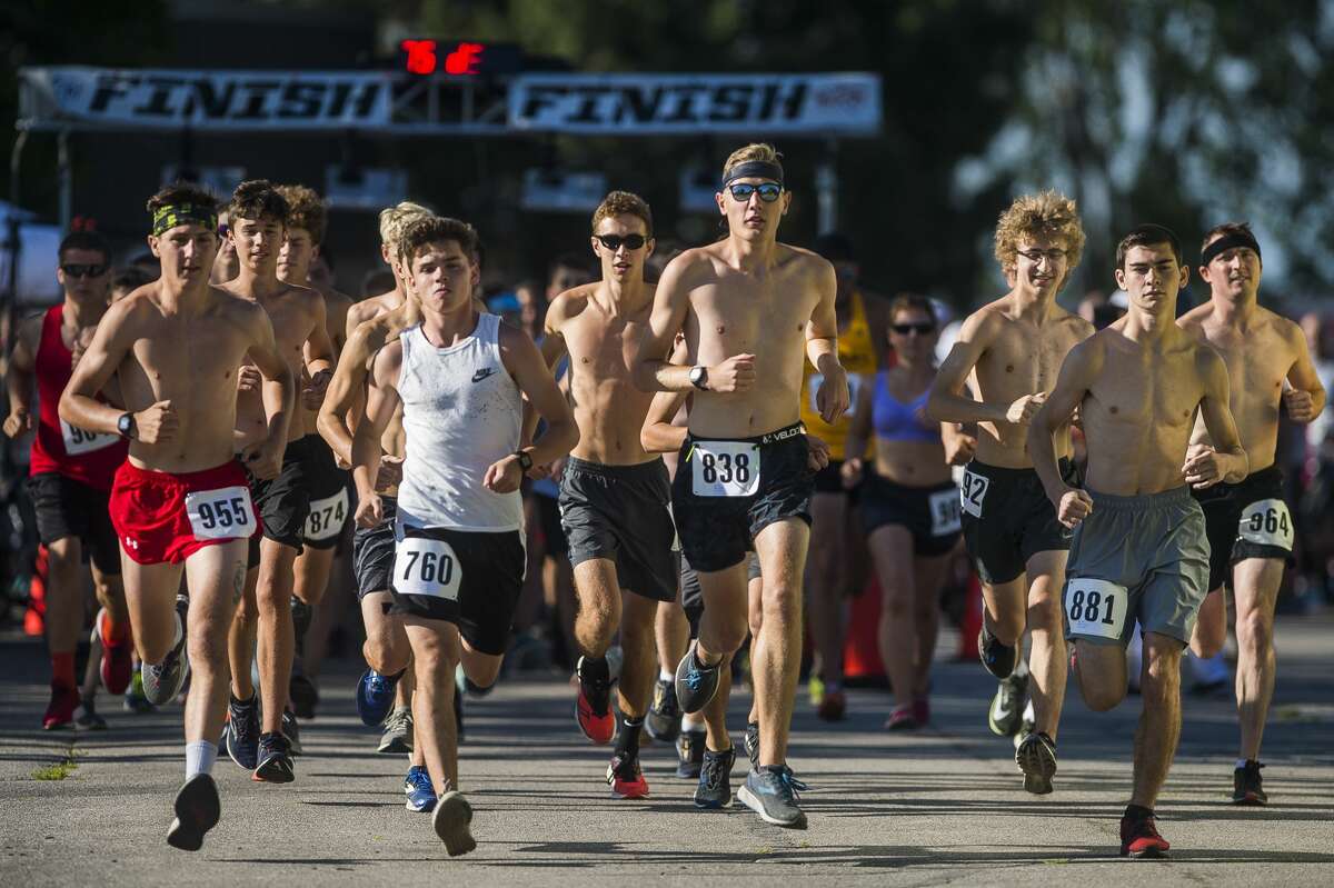 Runners take off at the start of the Cornstalk 5K on Thursday, July 11, 2019 at Bay City Western High School in Auburn. (Katy Kildee/kkildee@mdn.net)