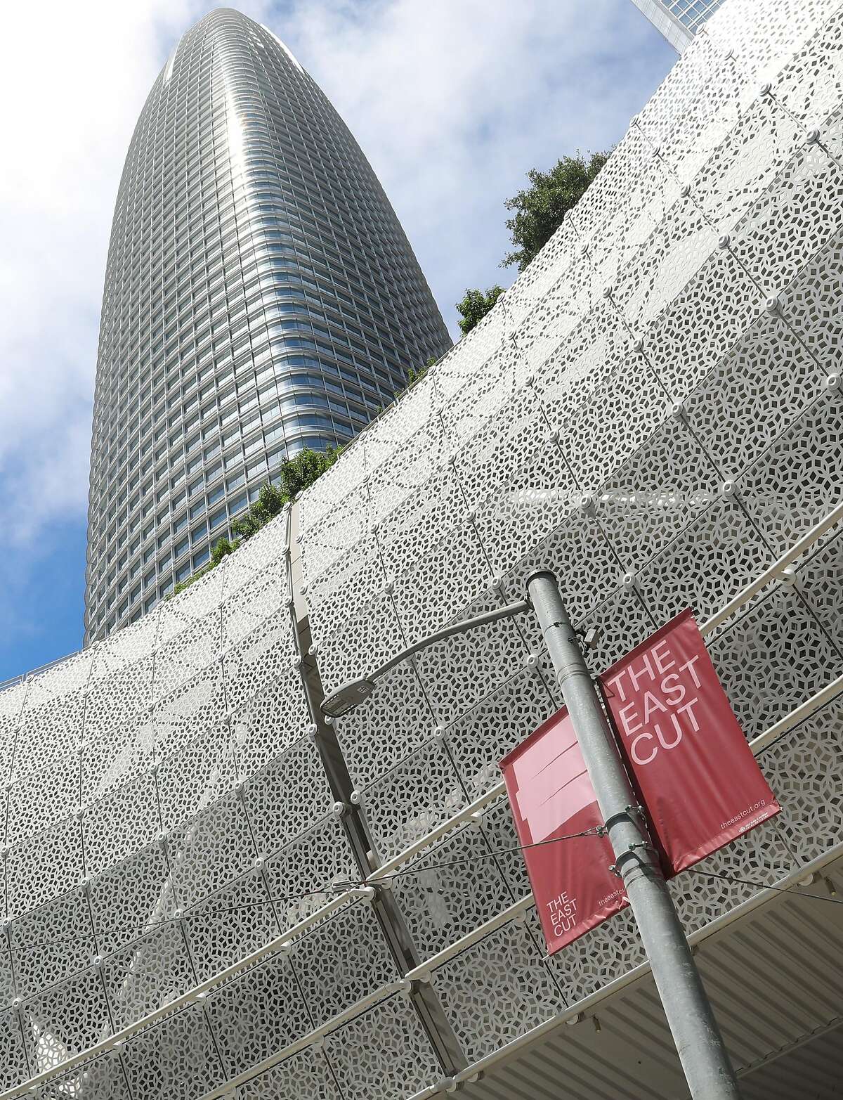 An East Cut district sign seen next to the Salesforce transit center and building on Thursday, July 11, 2019, in San Francisco, Calif.