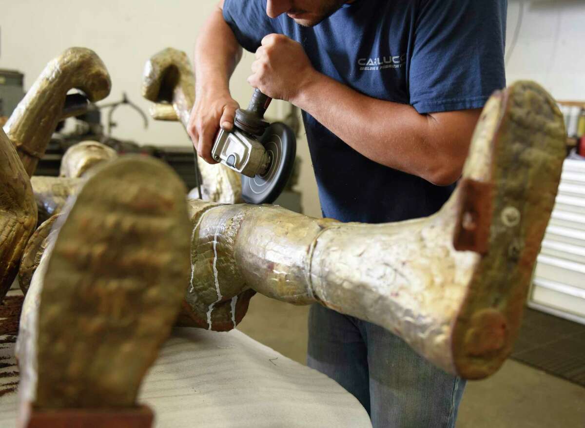 Canio Carlucci restores the shine to the bronze statues of boxers Muhammad Ali and Joe Frazier from Stamford's Boxer Square at Carlucci Welding and Fabrication in Norwalk, Conn. Wednesday, July 3, 2019. The statues are being restored by Canio Carlucci at his Norwalk studio and will be placed back at the newly restored Boxer Square later this month. The sculpture was made by Stamford's A.D. Richardson in the late 1970s and installed in Bpxer Square in the mid-1990s. The piece is meant to represent the two legendary fighters locked in battle on Oct. 1, 1975 in the Philippines during an epic boxing match known as the "Thrilla in Manila."