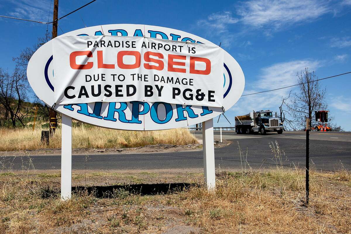 A banner blaming PG&E for the Paradise Airport closure is seen at Airport Road and Good View Drive, Friday, July 12, 2019, in Paradise, Calif. The town was damaged in the 2018 Camp Fire.
