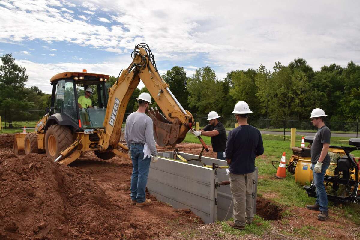 Individuals enrolled in a training program for natural gas utility technicians at Middlesex Community College in Middletown take part in a field training exercise.